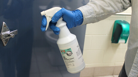 Neutral Germicidal Cleaner Spraying on restroom handle