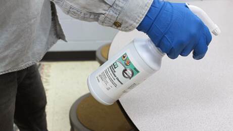 Neutral Germicidal Cleaner Spraying on table