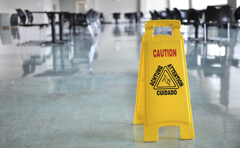 Caution yellow sign inside building hallway