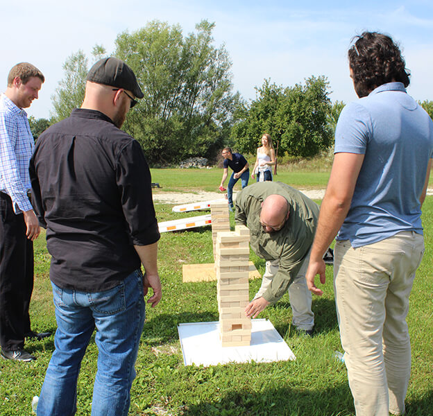 Essential is out playing games with giant Jenga and bag toss