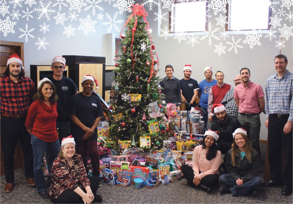 Essential employees and the toys that it donated to Toys for Tots