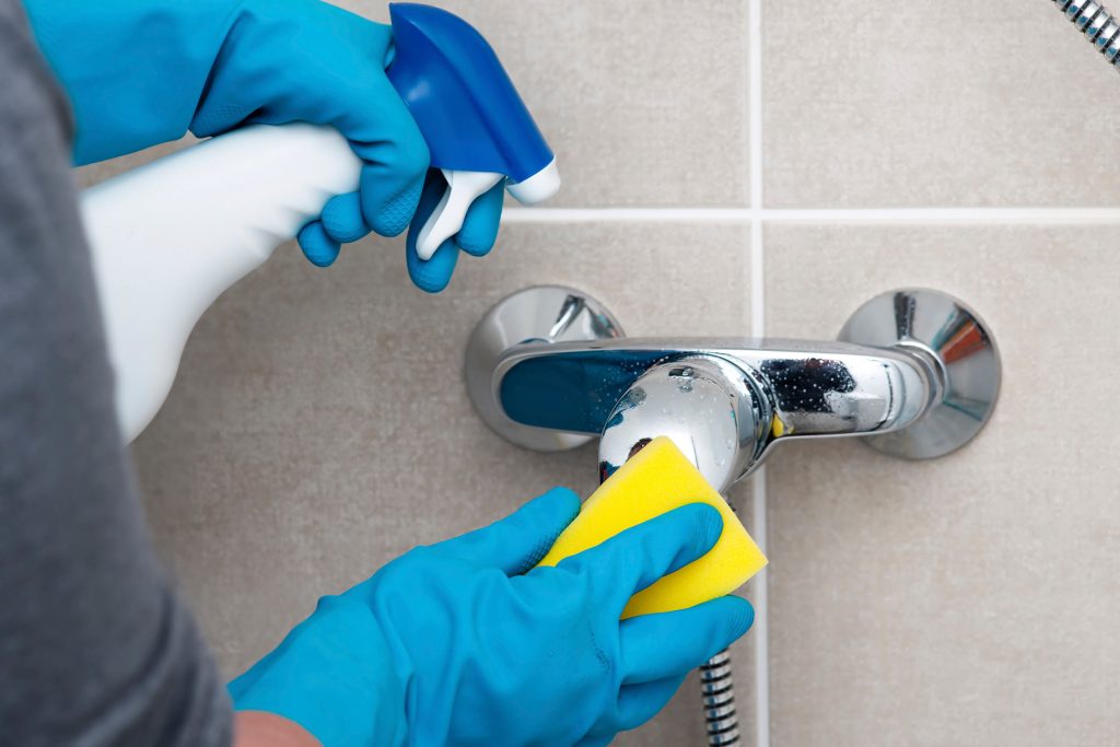 scrubbing a faucet