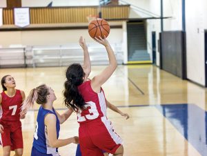 Diverse high school female basketball team playing a game